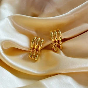 Polished gold geometric multi-layer hoop earrings with teardrop pendants on silk