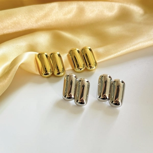 Minimalist capsule style copper stud earrings in polished gold and silver metallic finish