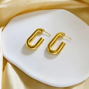 Chic 18K gold plated geometric U-shaped hoop earrings on elegant silk background