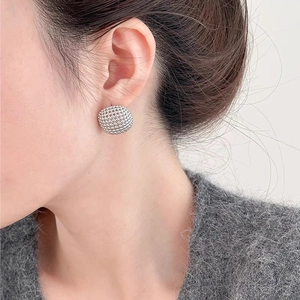 Textured silver hollow sphere stud earrings in minimalist geometric metal style