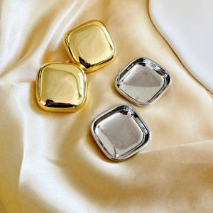 Square 18K gold and silver plated geometric earrings on elegant satin fabric