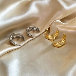Minimalist geometric C-shaped hoop earrings in polished gold and silver metal finishes