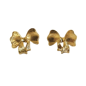 Minimalist 18K gold plated bow earrings with vertical textured finish on white background
