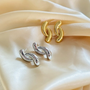 18K gold and silver plated geometric twisted earrings set on elegant champagne satin