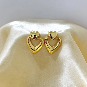 Polished 18K gold double heart earrings featuring nested geometric design on satin