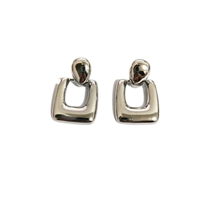 Polished silver geometric square drop earrings with teardrop stud on white background
