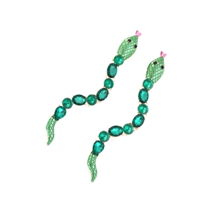 Macro detail of snake earrings with faceted green gemstones and textured scale patterns