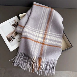 Detail view of purple plaid scarf with thick fringe and soft cashmere-like texture