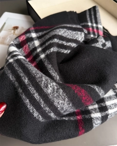 Detail of soft plaid scarf texture with classic black white and red checkered pattern