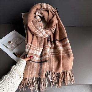 Macro detail of camel plaid cashmere scarf texture with soft tassels and woven fringe