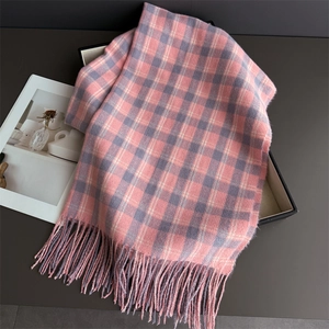 Détail de l'écharpe à carreaux rose et gris avec texture douce et finitions à franges fines