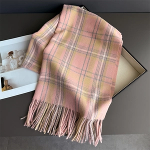 Detail shot of soft pink and yellow plaid cashmere scarf with long fringe tassels