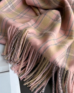 Detailed macro view of the soft plaid cashmere-feel scarf with long fringe tassels