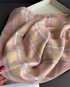 Close-up of pink and yellow plaid scarf texture showing soft cashmere-like fabric