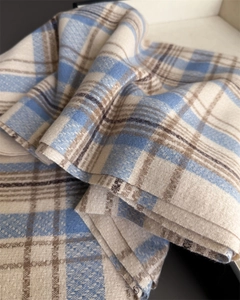 Close-up of soft plaid scarf showing thick brushed texture and blue-beige checkered pattern