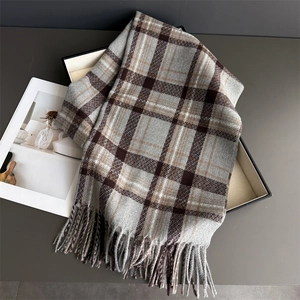 Macro detail of classic plaid cashmere-like scarf with soft fringe tassels and texture