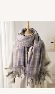 Detail of soft imitation cashmere scarf with classic plaid pattern and fringe tassels