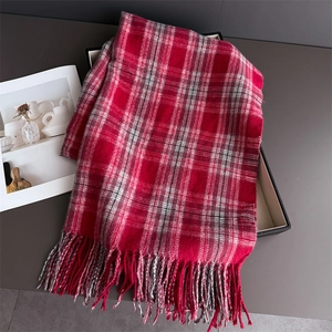 Detailed close-up of red and white plaid scarf with fine soft fringe tassels
