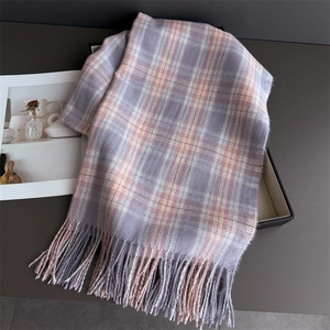 Detail of soft plaid scarf with tassels in pastel purple and beige in a gift box