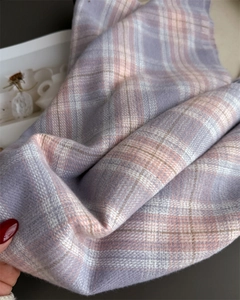Detail view of soft plaid cashmere scarf with lavender and pink fringe texture