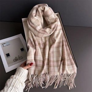 Detail of soft beige and pink plaid scarf with tassels in a premium gift box