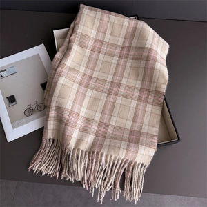 Detailed texture of plaid scarf fringe in beige and pink on a display box