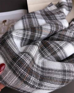 Close-up of soft grey and white plaid scarf fabric with detailed woven texture