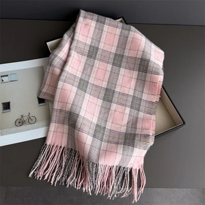Detail of soft plaid scarf fringe and woven texture in pink and grey shades