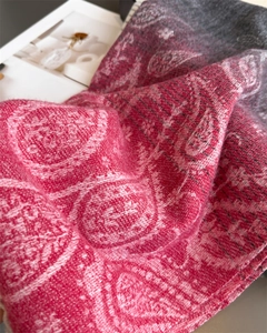 Detail of soft paisley patterns on a gradient pashmina shawl with tassel texture