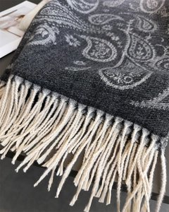 Detail view of high-quality dark grey paisley scarf with elegant white fringe tassels