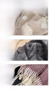 Detail of camellia pattern jacquard and fringe on beige, grey and red scarves