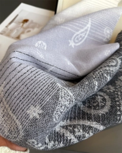 Macro shot of paisley pattern weave on gray-blue and dark gray cashmere-like winter scarf