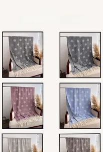 Detail of camellia floral shawls with fringe in multiple colors for winter fashion