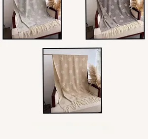 Detail of camellia flower pattern and fringe on luxury cashmere-like scarves in three colors