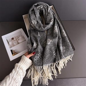 Close-up of camellia jacquard pattern and long tassel on grey pashmina shawl