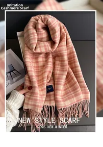 Close-up of pink and white plaid cashmere-like scarf with fringe and brand label
