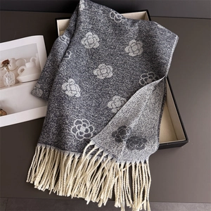 Macro detail of dark grey camellia flower jacquard scarf with thick twisted tassels