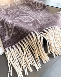 Close-up of paisley pattern pashmina with soft cream tassels and thick knit texture