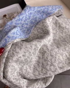 Detailed close-up of high-quality two-tone gray and blue jacquard knit texture scarf