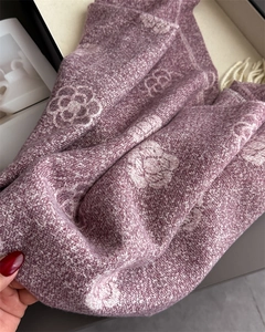 Close-up of the elegant camellia flower pattern on the pink knit cashmere pashmina shawl