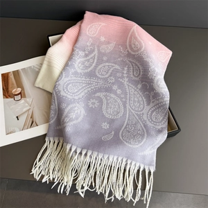 Detailed view of paisley print on winter scarf with fringe and purple color gradient