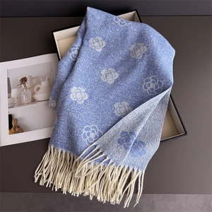 Detailed view of light blue camellia scarf with cream fringes and knit texture