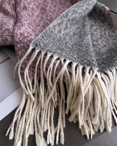 Close-up of color-block scarf with light purple and grey knit and soft white tassels