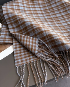 Detail of plaid scarf with soft knit texture and dual-color twisted tassel fringes