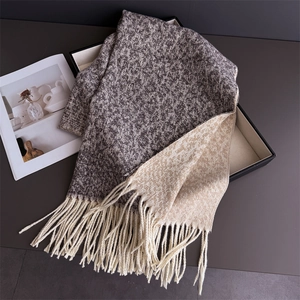 Detail of leopard print double-sided scarf with long fringe tassels in grey and beige