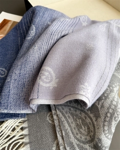 Close-up of paisley jacquard scarf with premium tassels and soft cashmere-feel fabric