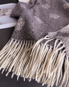 Close-up of camellia pattern cashmere-feel scarf with elegant hand-knotted tassels