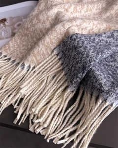 Macro shot of stylish color-block cashmere-feel scarf with elegant fringes and knit texture
