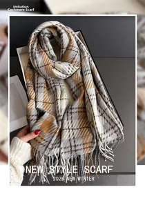 Close-up of soft plaid cashmere-like scarf texture with fringe details and hand touch