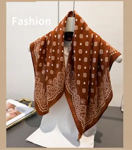 Detailed texture of caramel paisley cotton scarf draped over a minimal outfit
